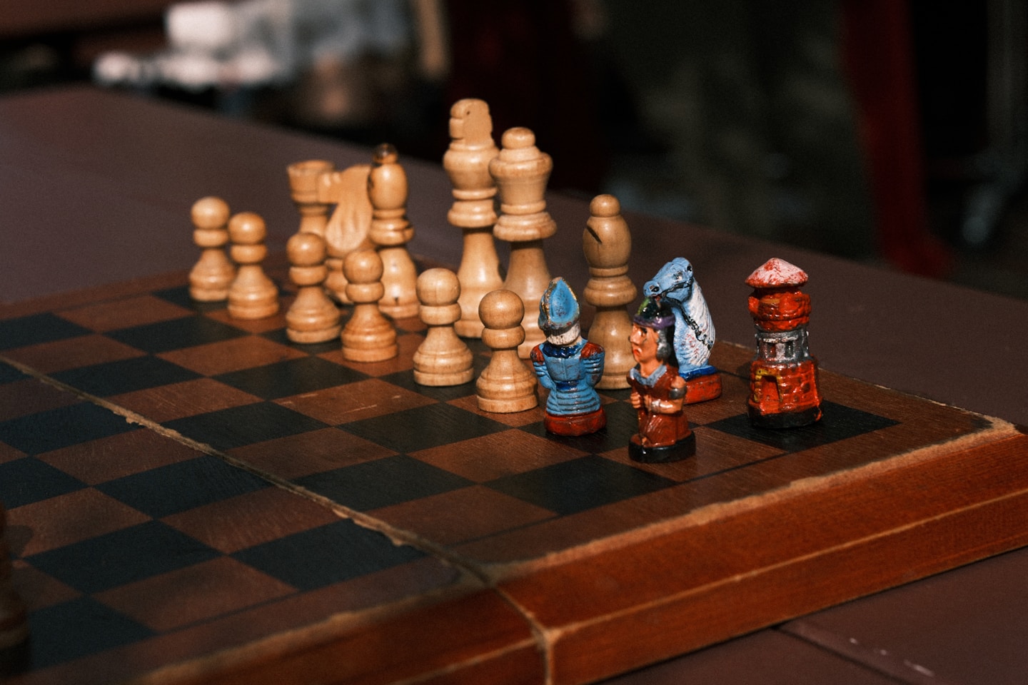 Chess pieces arranged on a wooden chessboard