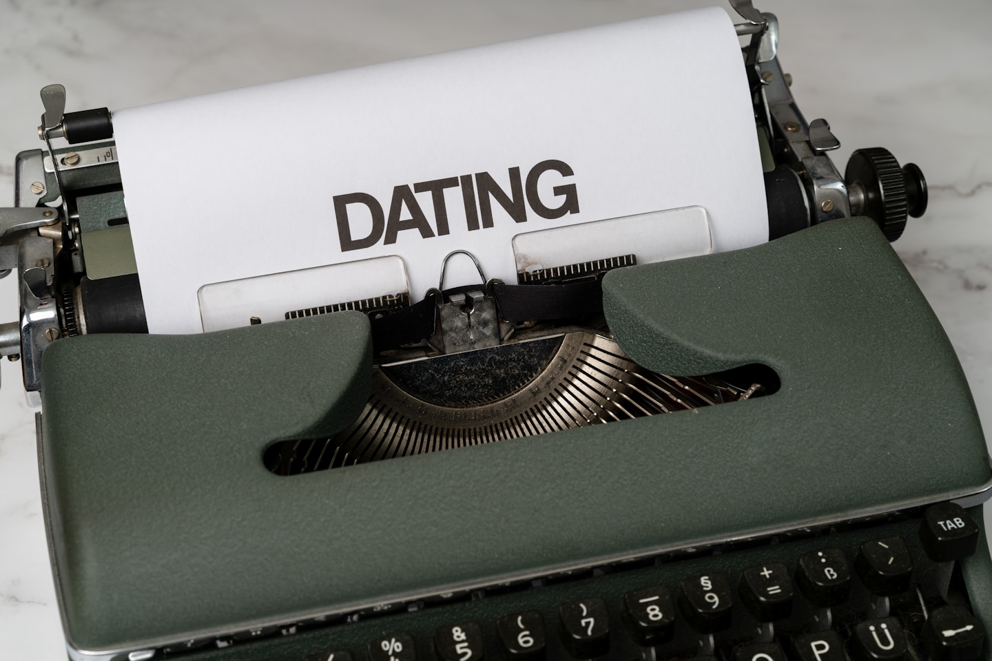 a close up of a typewriter with a paper on it